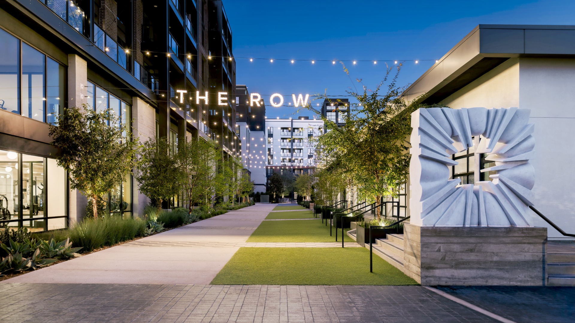 The Row exterior under hanging lights with art installation