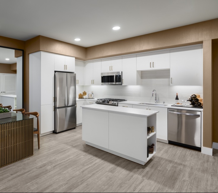 Spacious and well lit kitchen with wood floors and moveable island