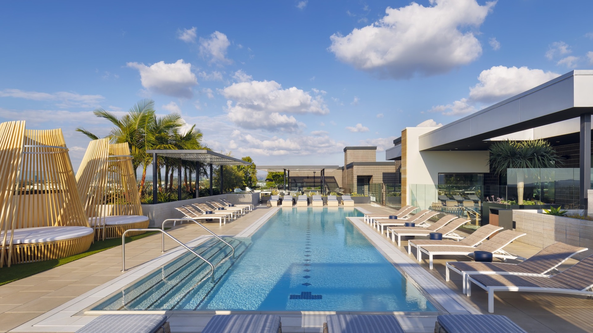 Resort-style swimming pool with lounge seating