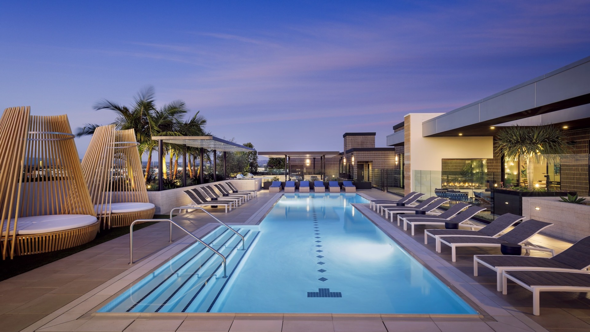 Resort-style swimming pool with lounge seating
