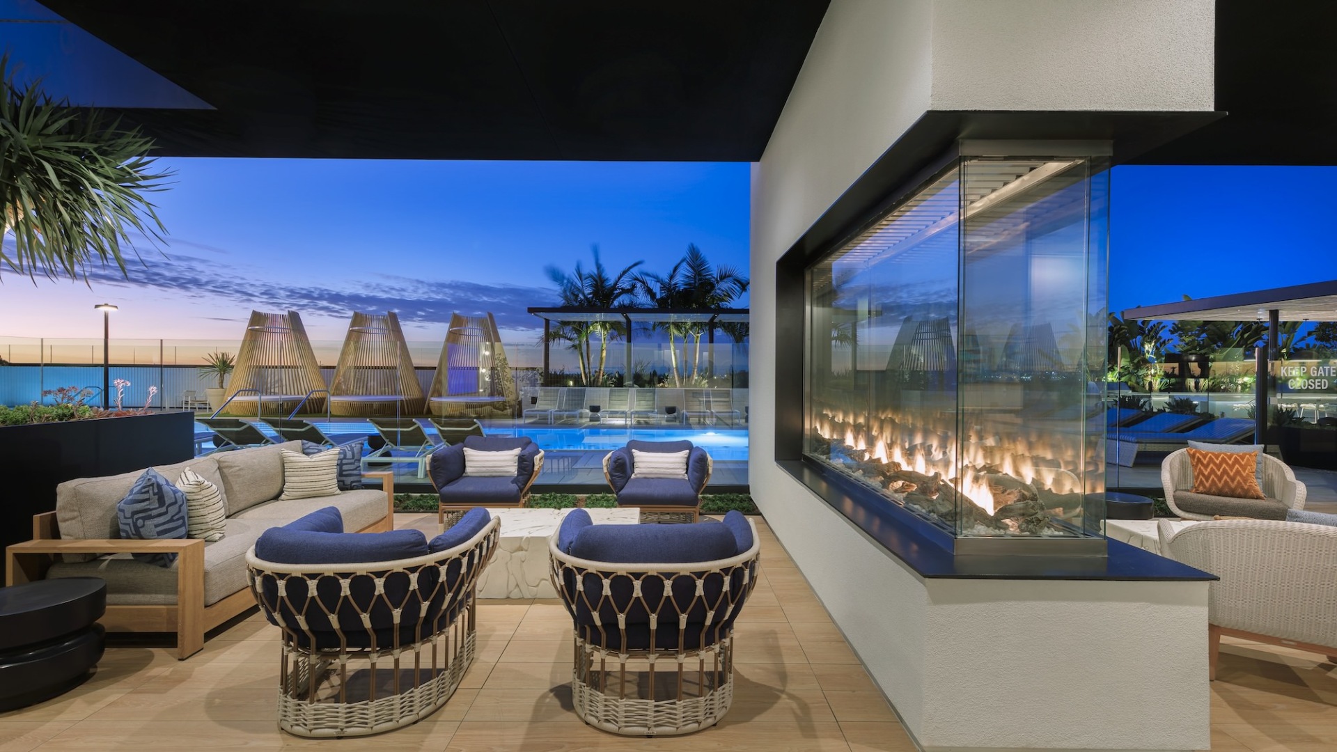 Resort-style swimming pool with lounge seating and a fireplace