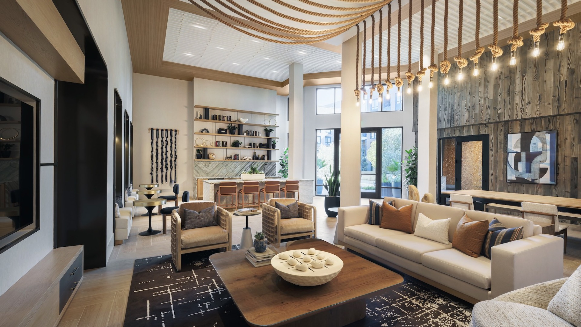 a spacious gathering lounge with sofas and chairs