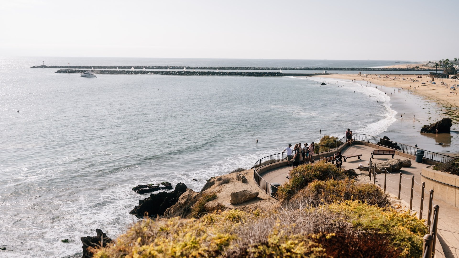 People standing overlooking an inlet 