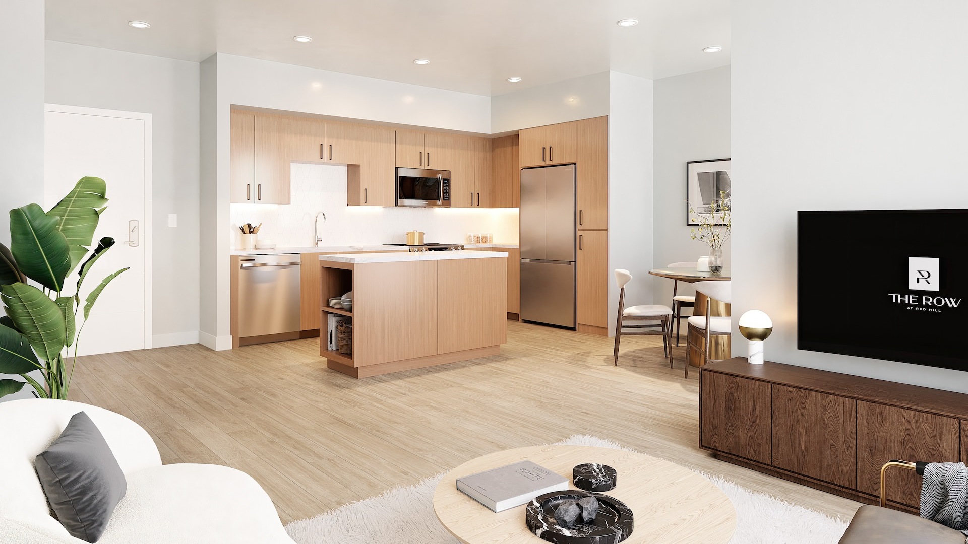 Spacious and well lit kitchen with stainless steel appliances and dark accents 