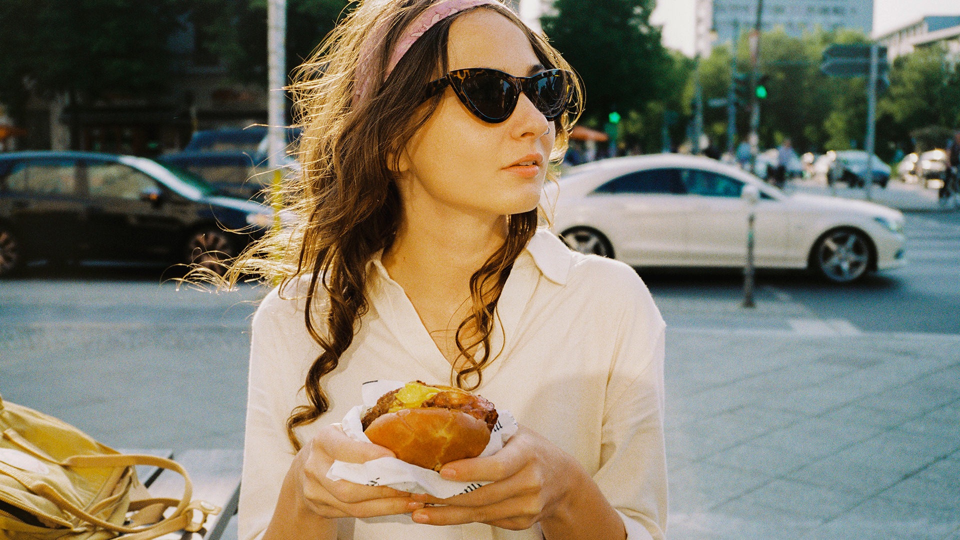 person outside eating a hamburger 