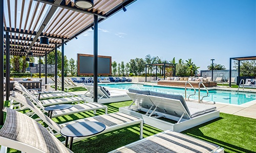 a large swimming pool surrounded by cabanas