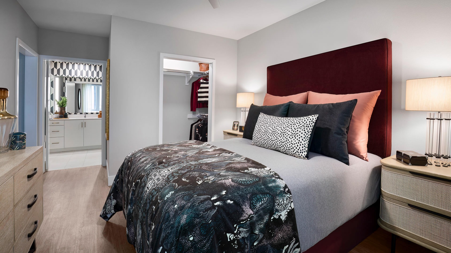 ceiling fan and light fixture in bedroom with walk-in closet