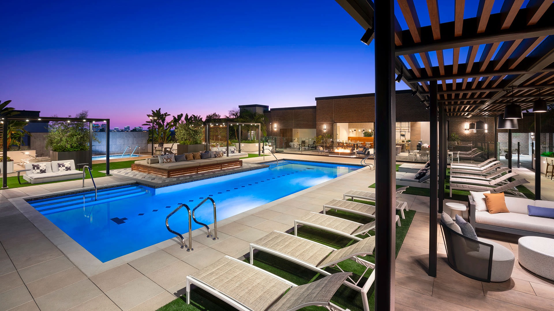 swimming pool lit at night on rooftop aqua deck