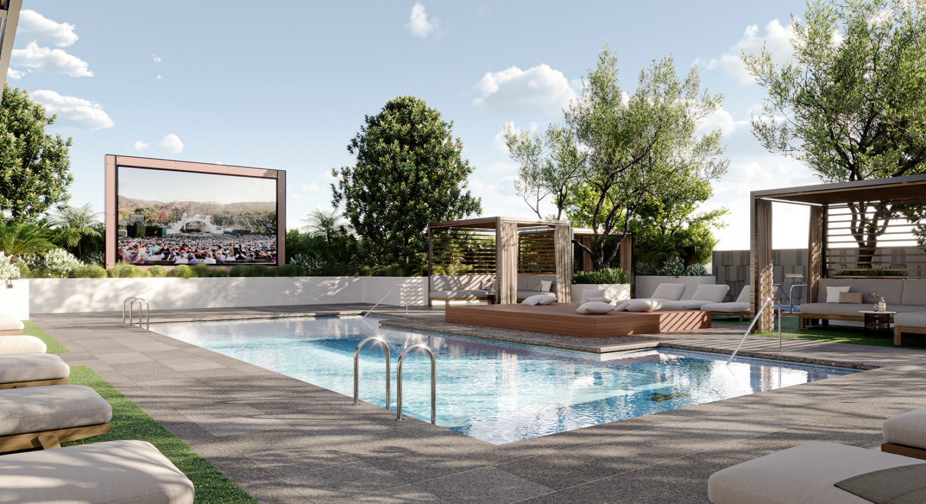 Large sparkling blue pool with a large deck and lounge chairs 